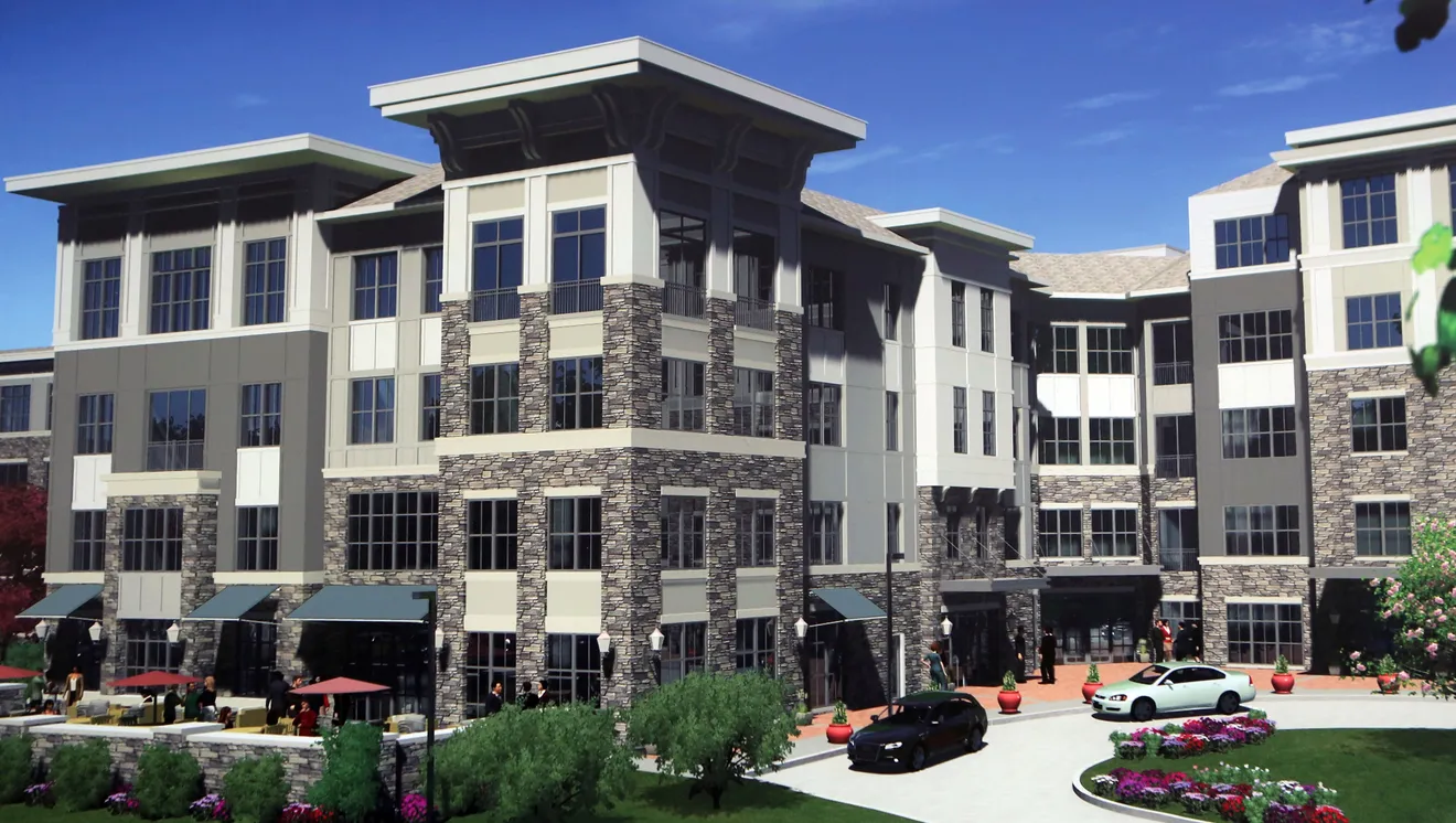 Exterior of apartment building with two cars in the front