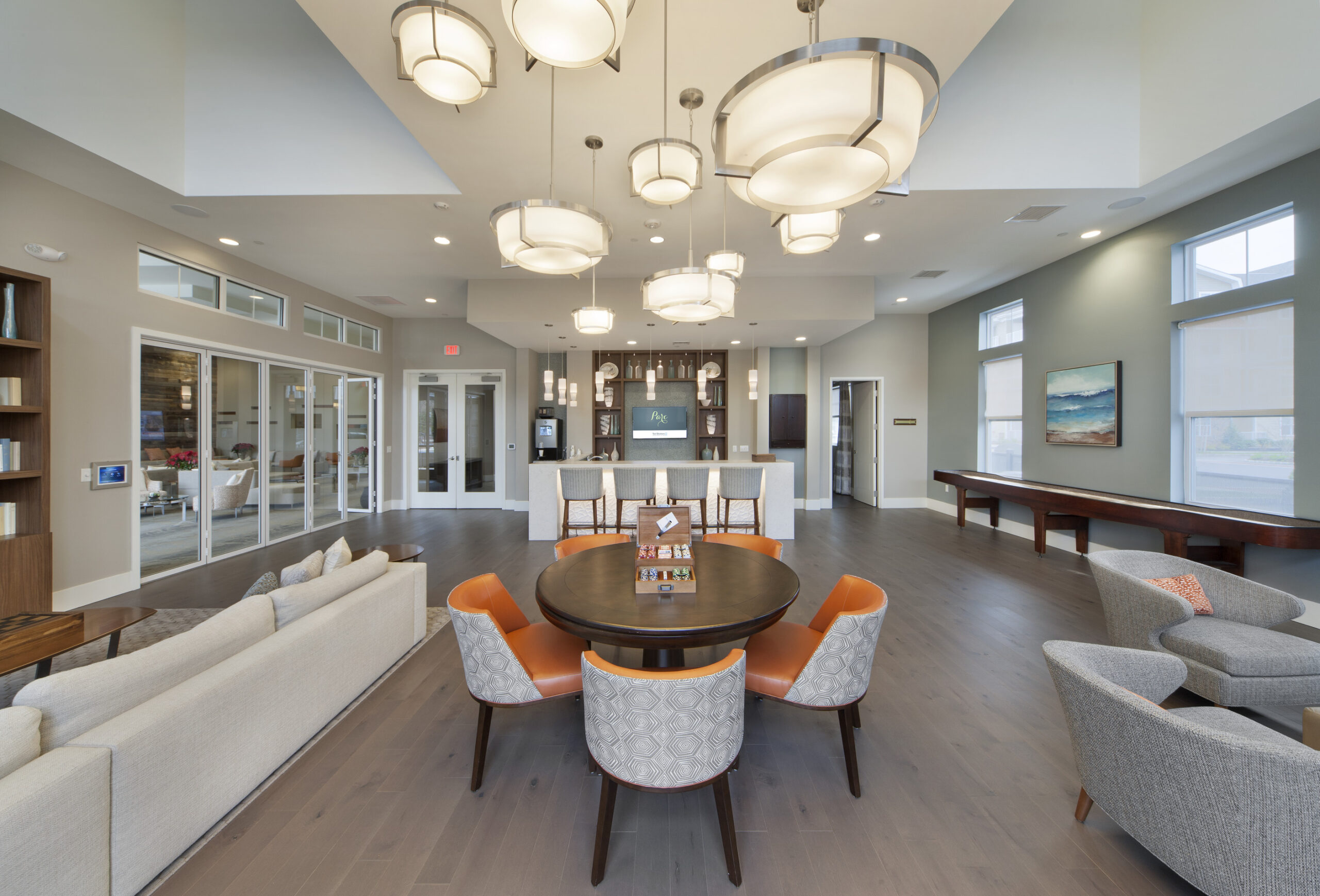 Parc Plymouth Meeting's resident lounge with couches, poker table, bar seating, and games