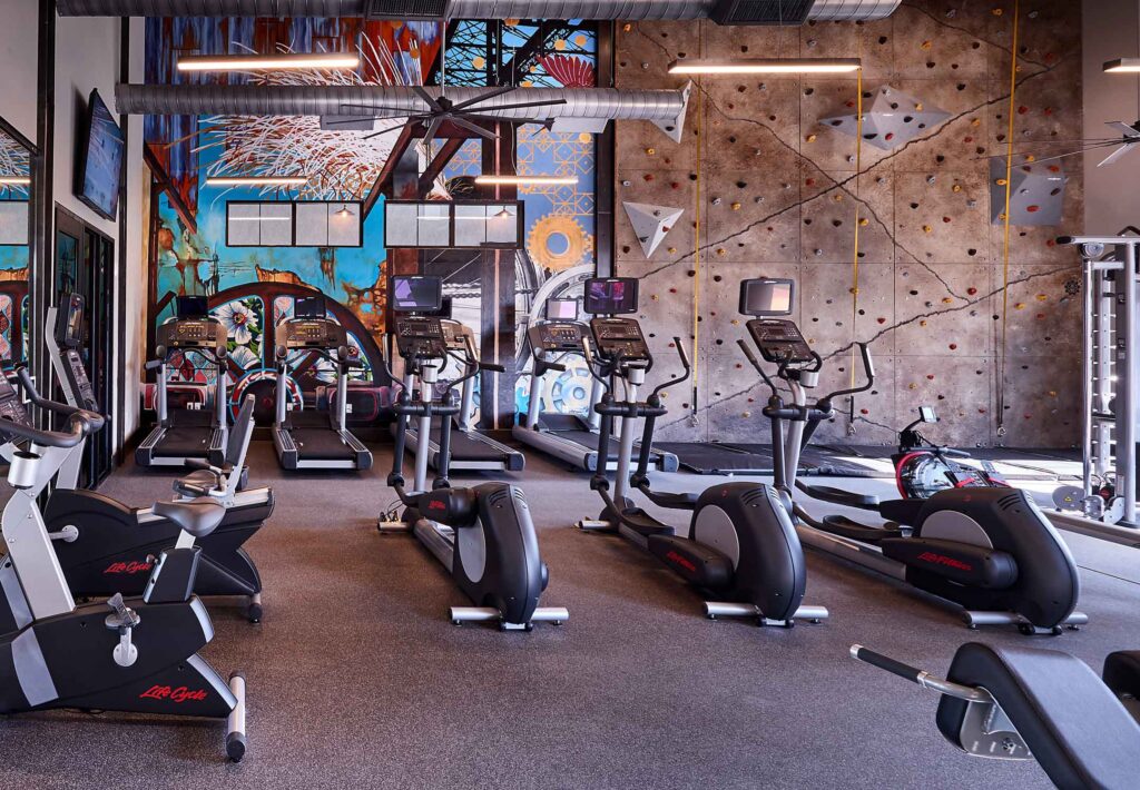 Elliptical machines and climbing wall in fitness center at Riverworks