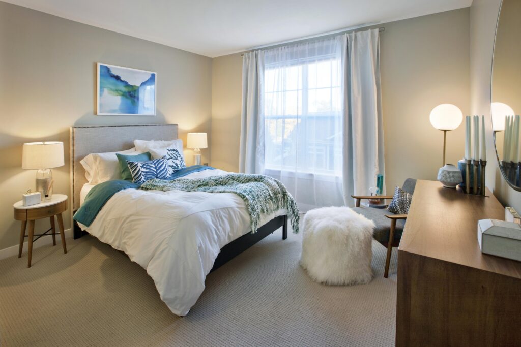 Bedroom at Parc Westborough with bed, chair, ottoman and dresser