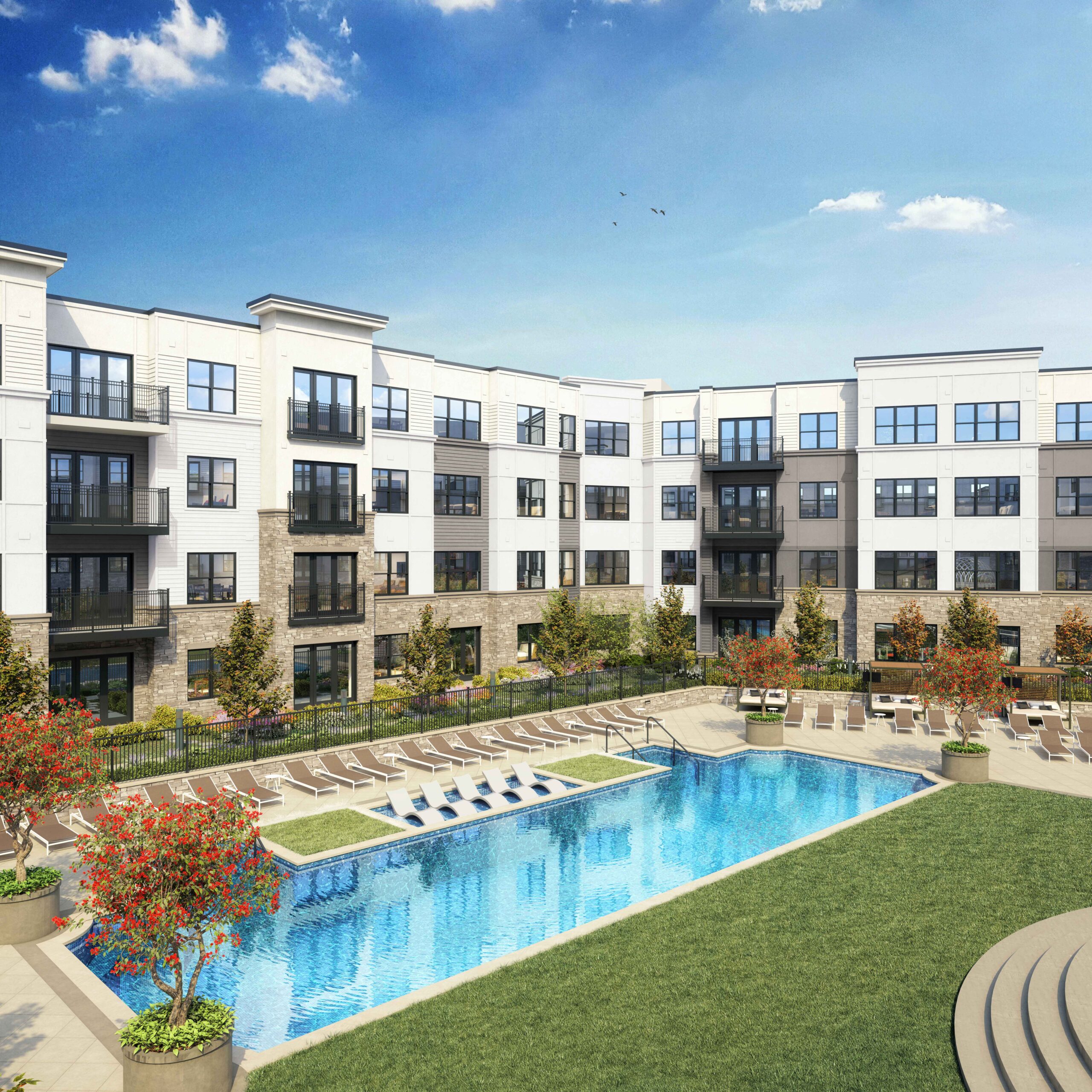 Pool and lounge chairs with apartment building in the background