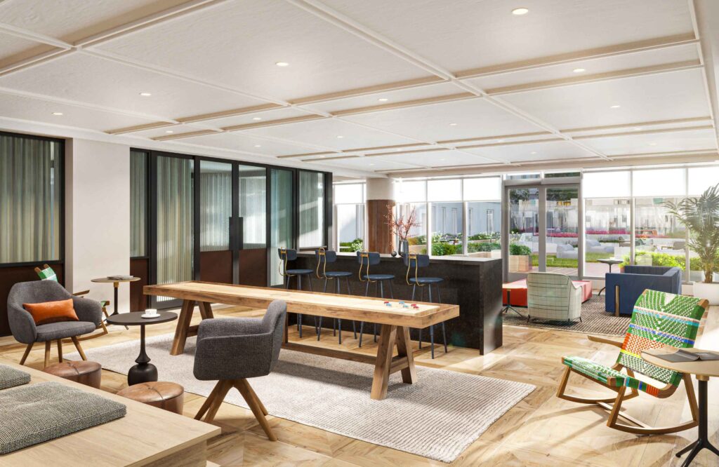 Indoor resident lounge with seating area and shuffle board