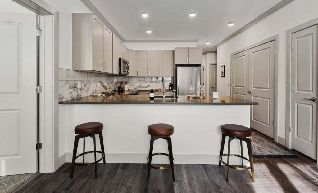 Barstools beside counter in modern kitchen at Carraway