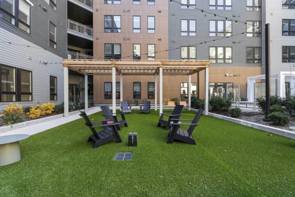 Adirondack chairs and pergola in courtyard at Emblem 120