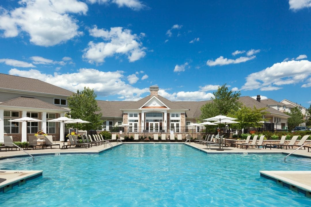Pool, lounge chairs and umbrellas at The Mews at Princeton Junction