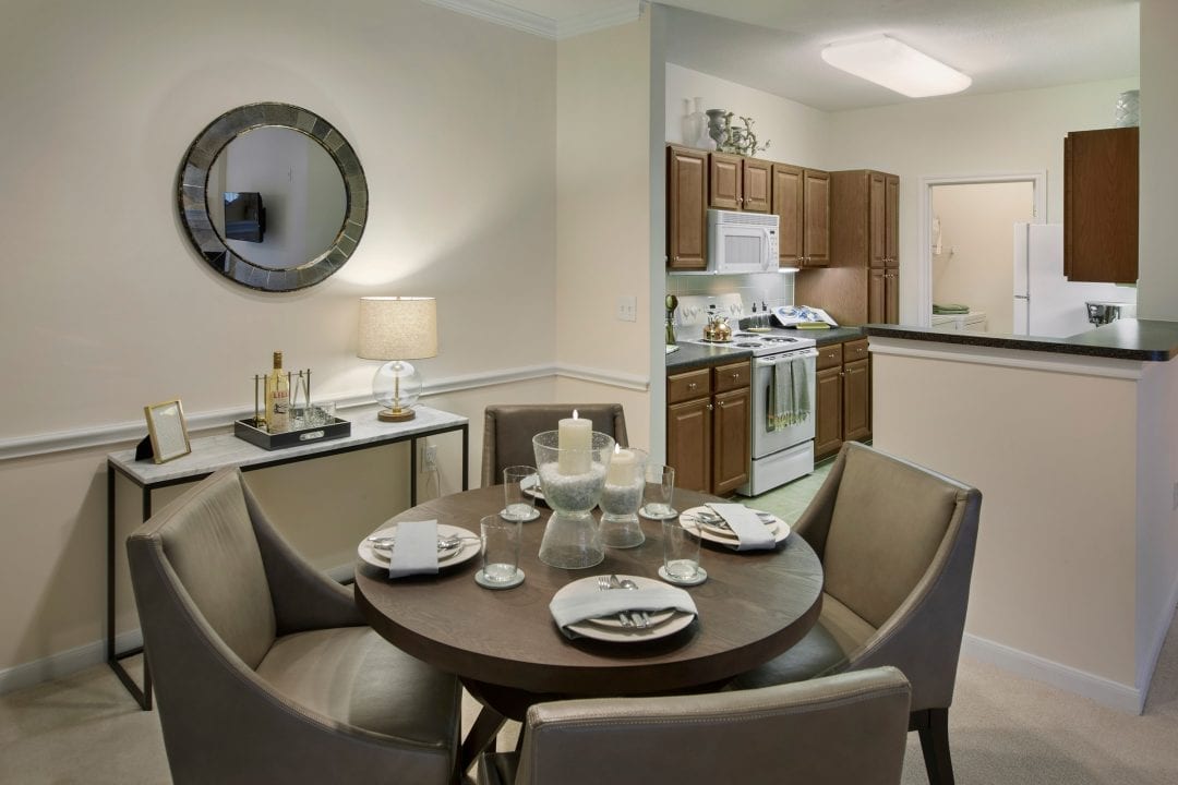 Dining area with kitchen in the background at The Mews at Princeton Junction