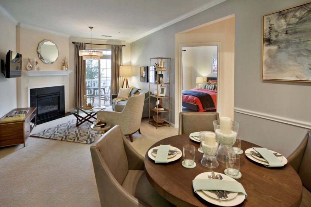 Dining and living areas with bedroom in background at The Mews at Princeton Junction