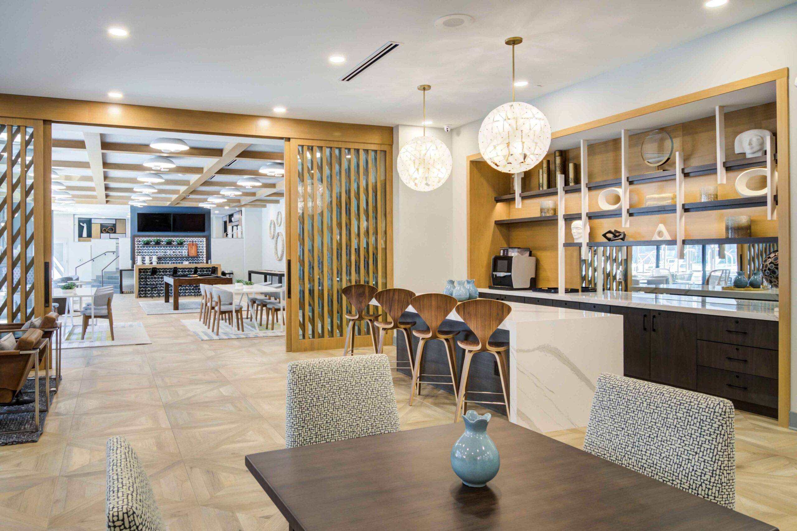 Table and chairs, bar, and barstools in lounge at Oleander