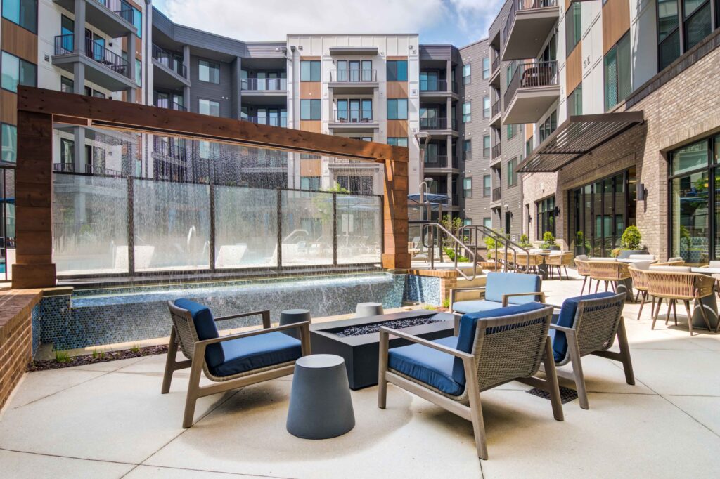 Outdoor lounge area with fire pit table at Oleander