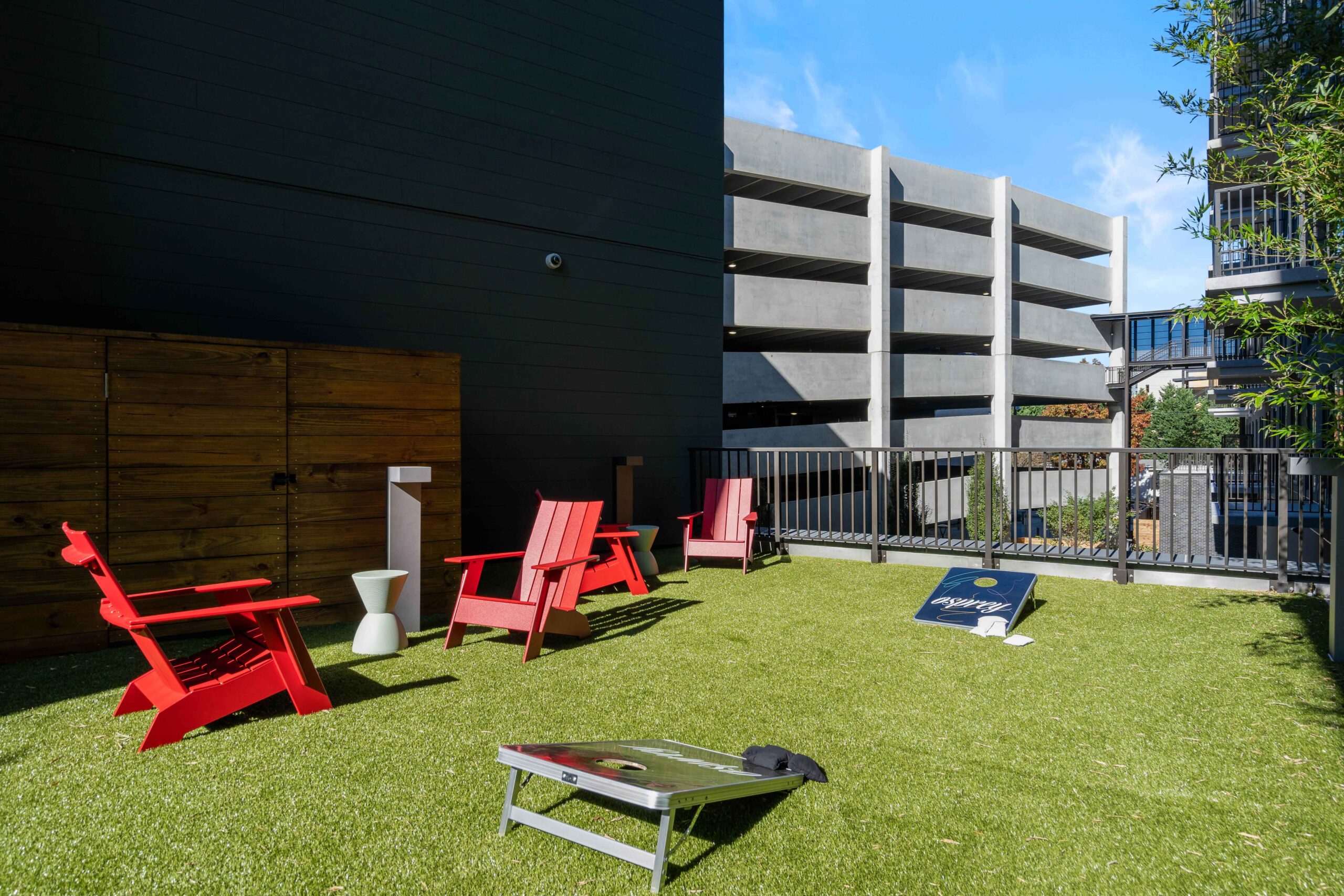 Corn hole and chairs on patio at Osprey