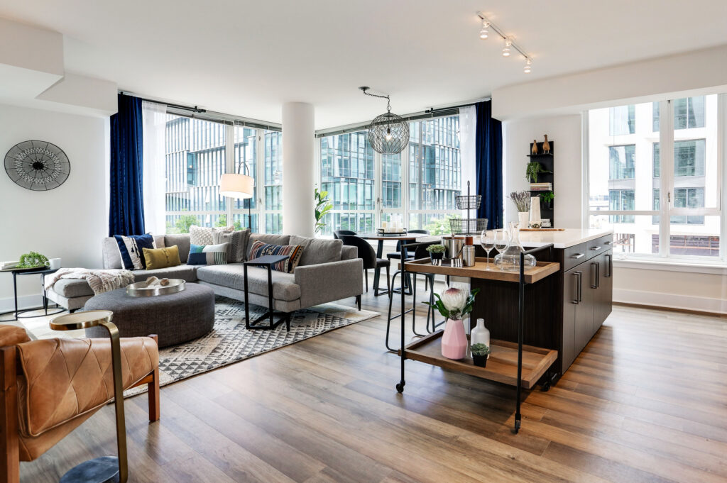 Model living room at Parc Riverside with large windows and open floor plan