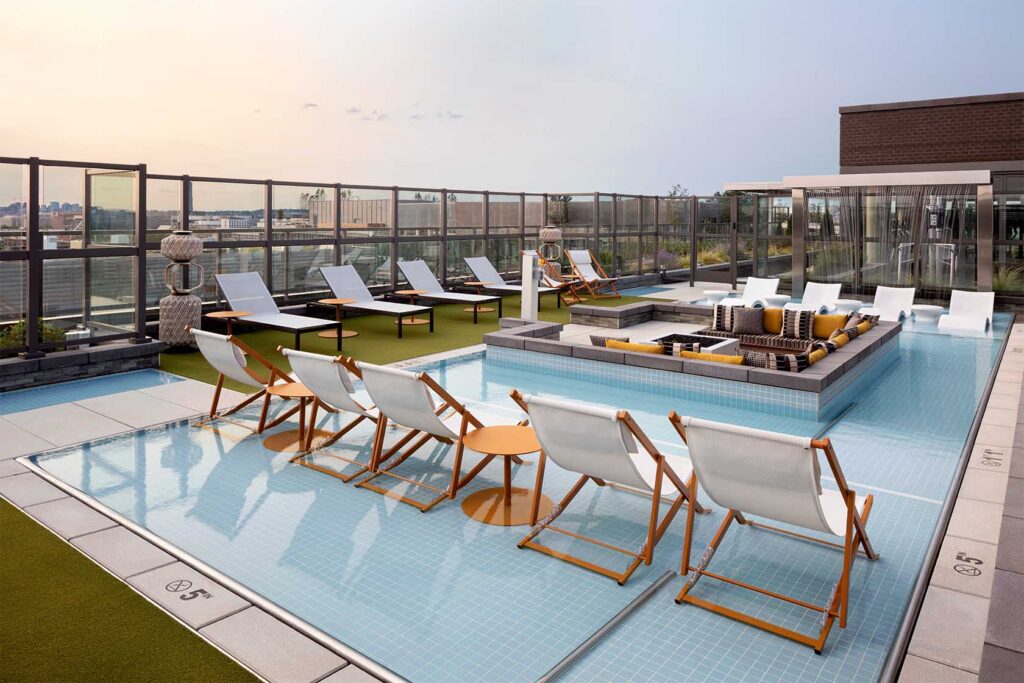 Rooftop pool with lounge seating at Parc Riverside