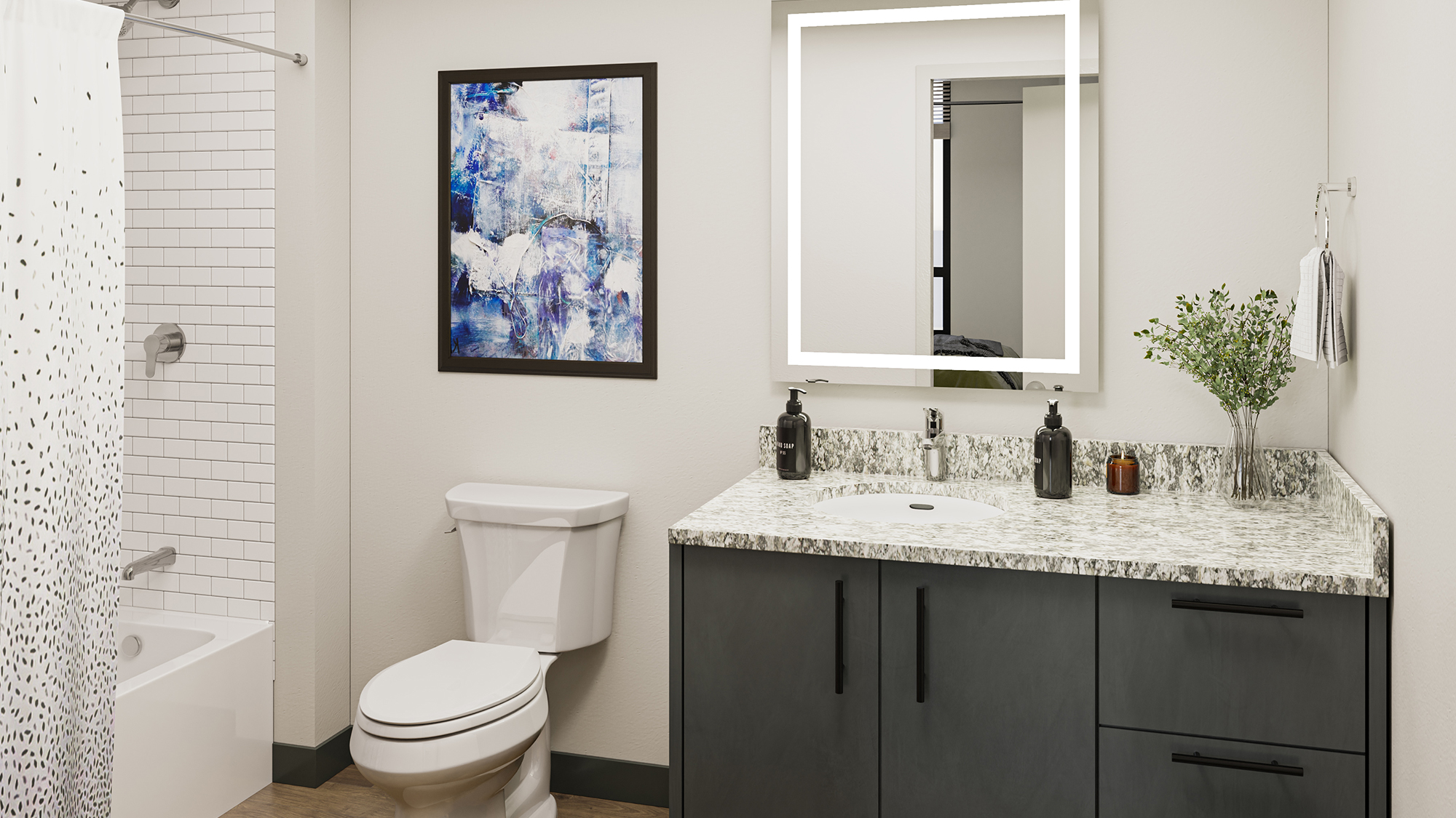 Bathroom with gray cabinets and countertop, lighted vanity, and show with patterned shower curtain.