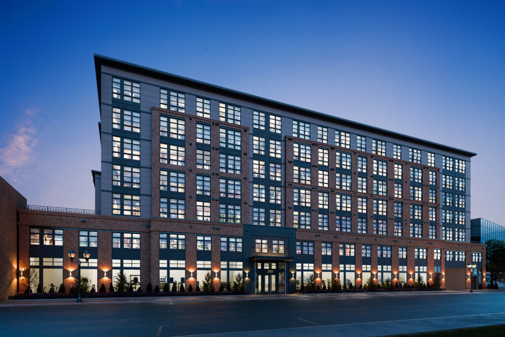 Exterior of Julius at dusk with lights shining in the windows