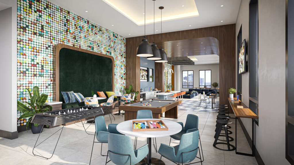 Resident lounge with pool and foosball tables, seating areas, and accent wall with a colorful circular pattern.