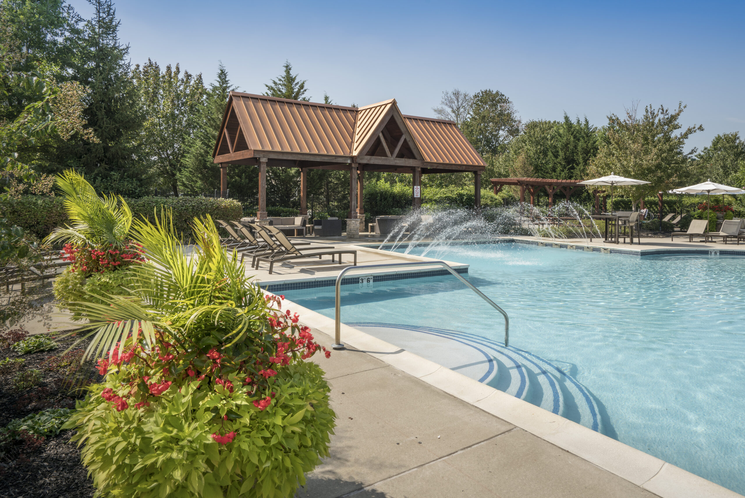 Pool and lounge chairs with a pavilion in the background