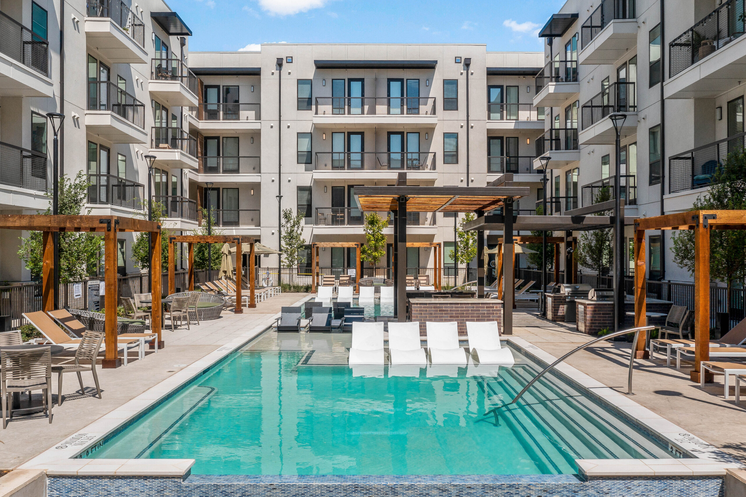 Pool, outdoor lounge area, and pergolas at Ferro