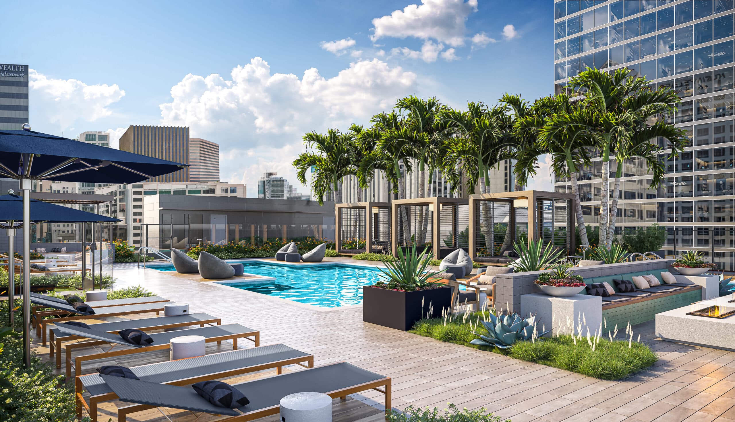 Pool deck on a rooftop with palm trees and lounge seating